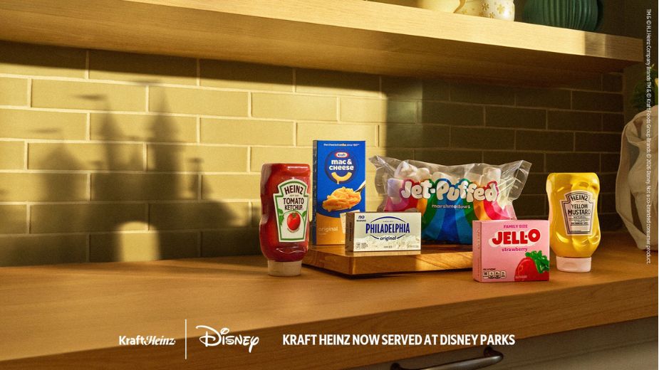 The Kraft Heinz Disney Partnership - Kraft Heinz product lineup including Heinz Tomato Ketchup, Kraft Mac and Cheese, Philadelphia cream cheese, Jet-Puffed marshmallows, Jell-O strawberry, and Heinz Yellow Mustard, with the Kraft Heinz and Disney logos and the tagline "Kraft Heinz Now Served at Disney Parks" 